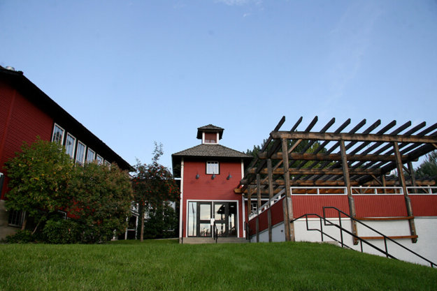 kelowna schoolhouse outside with red bricks and wood trellis