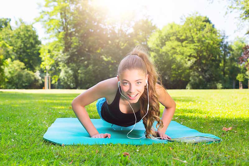 a teen practices push ups that she learned while in boot camp for behavioural treatment