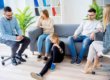 family in a therapist's office participates in family therapy activities on a couch