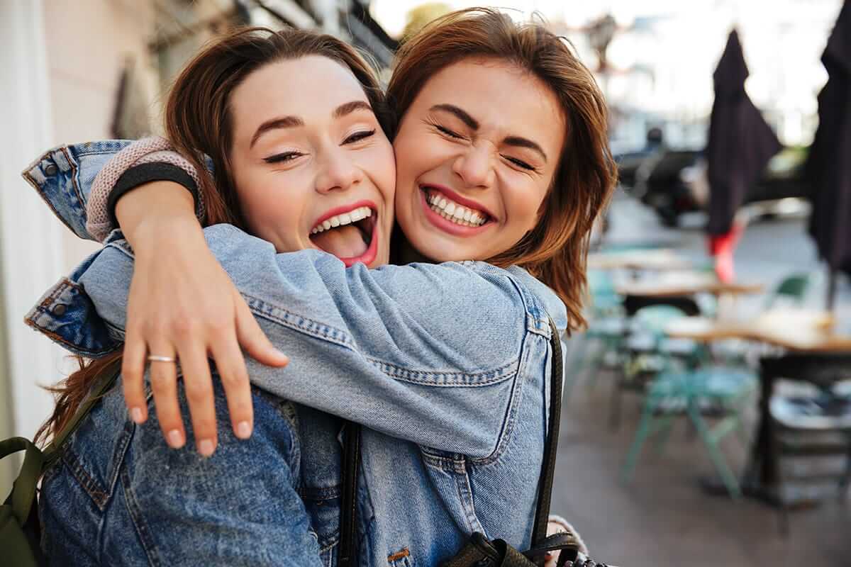 two women hugging each other on world mental health day