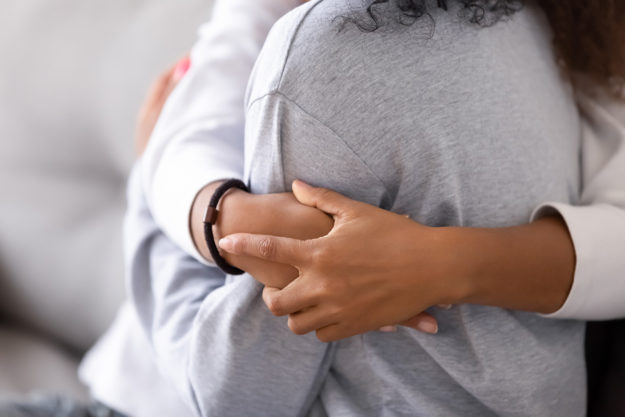 parent hugging child during national recovery month