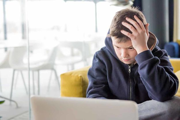 a boy struggles with adhd during his school work