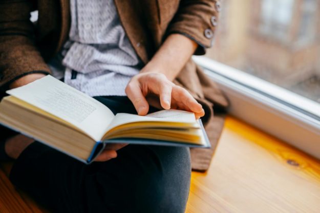 a troubled teen settles in comfortably to read a self-help book