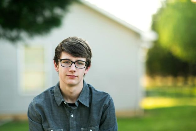 a neurodivergent teen smiles at the camera