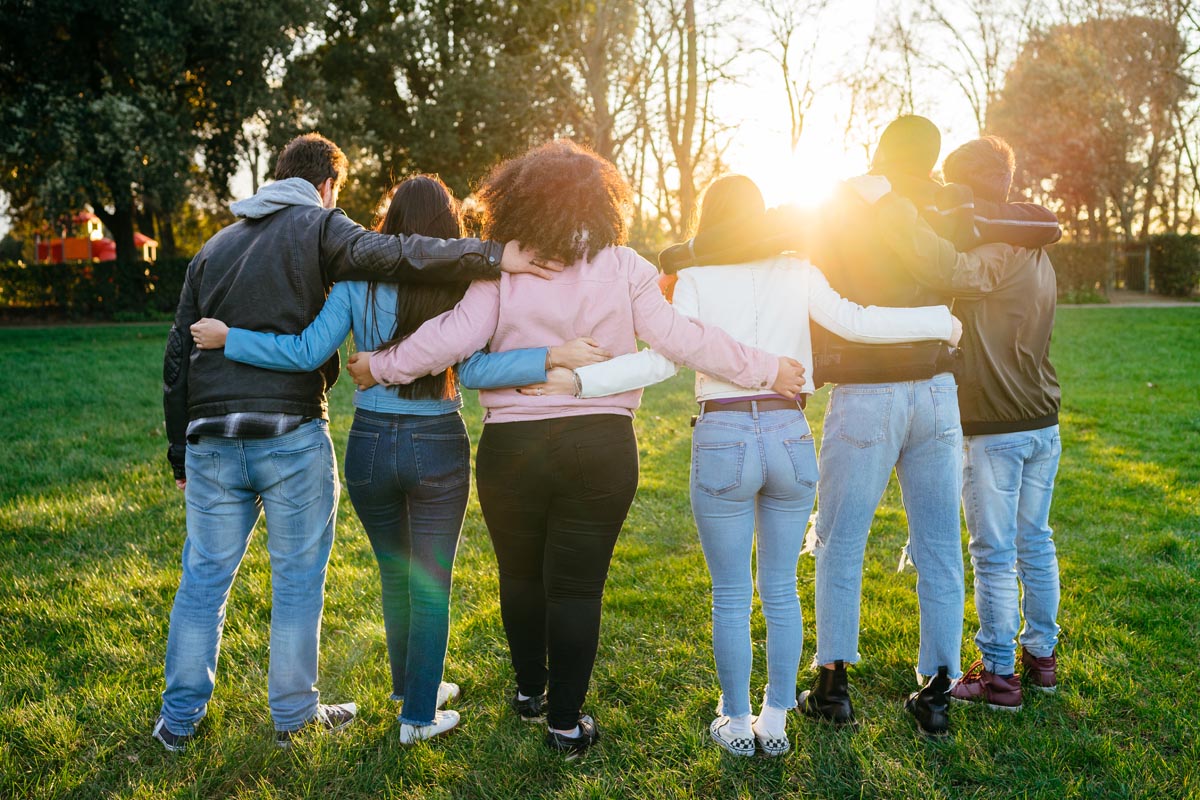 group of teens are outside with their arms around each other at residential treatment for teens