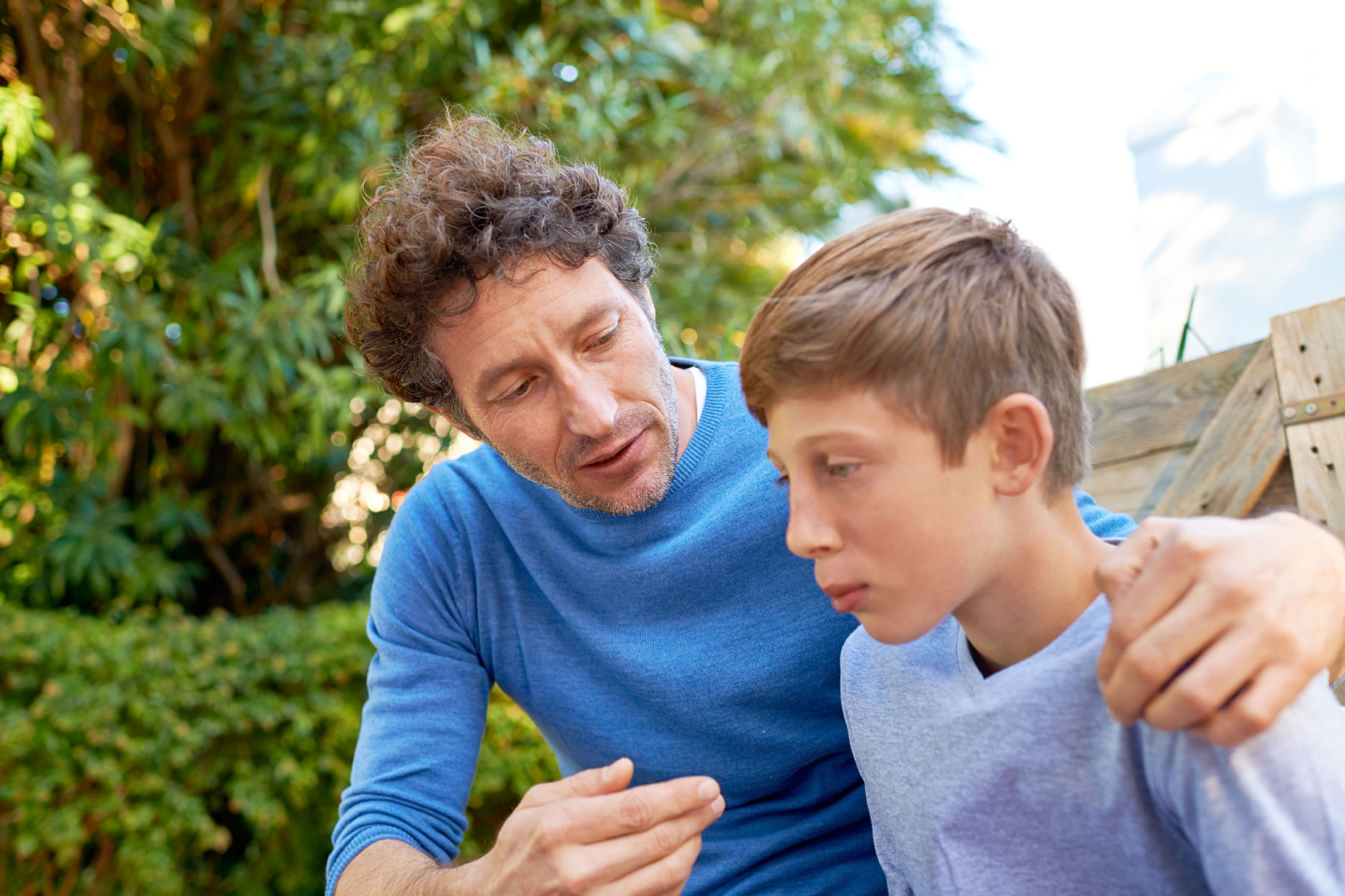 a parent experiencing potential burnout tries to comfort his teen